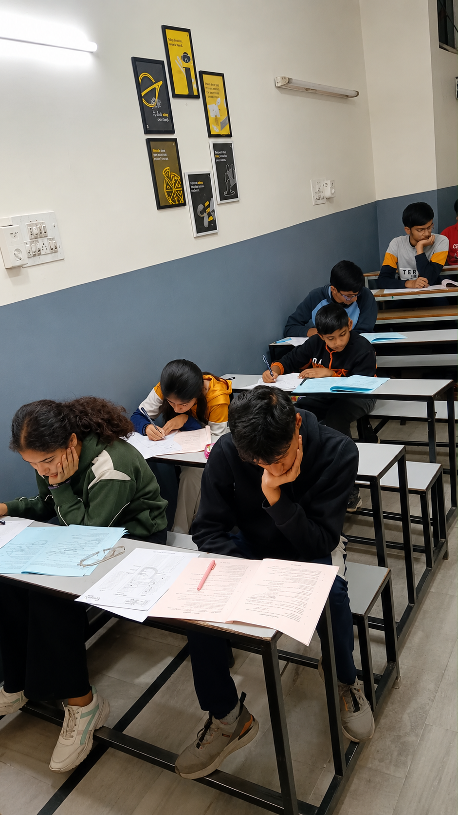 Genesis students concentrating on their examination papers